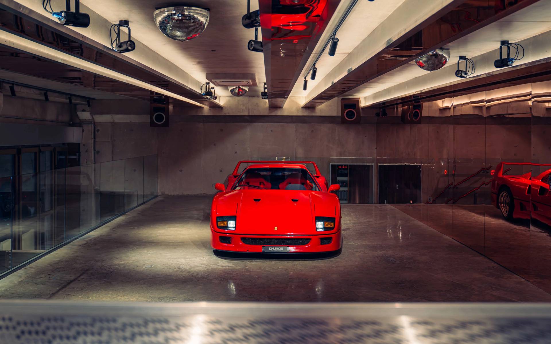 Head-on view of a classic red Ferrari F40 inside a high-end commercial location venue from Love Locations.
