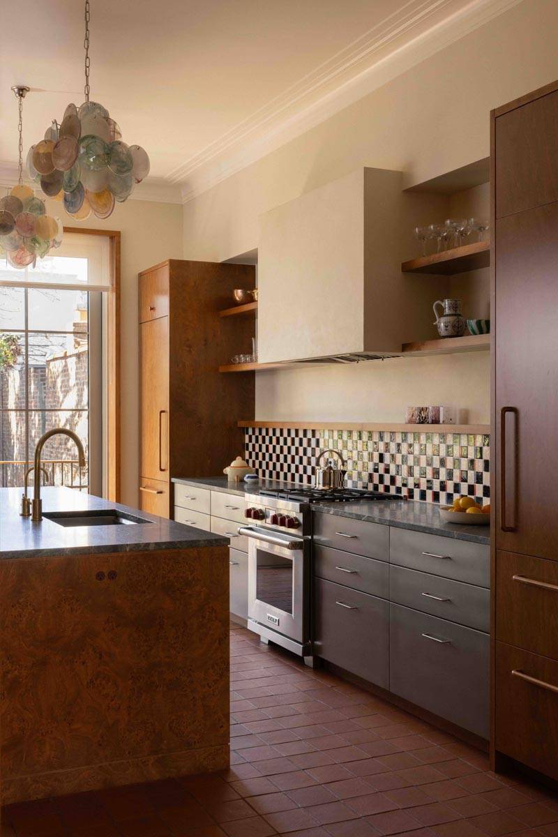 Spacious modern kitchen filming location in a Brooklyn NY 11217 townhouse from Love Locations, featuring custom wooden cabinetry, professional stainless steel range stove, and bright natural light.