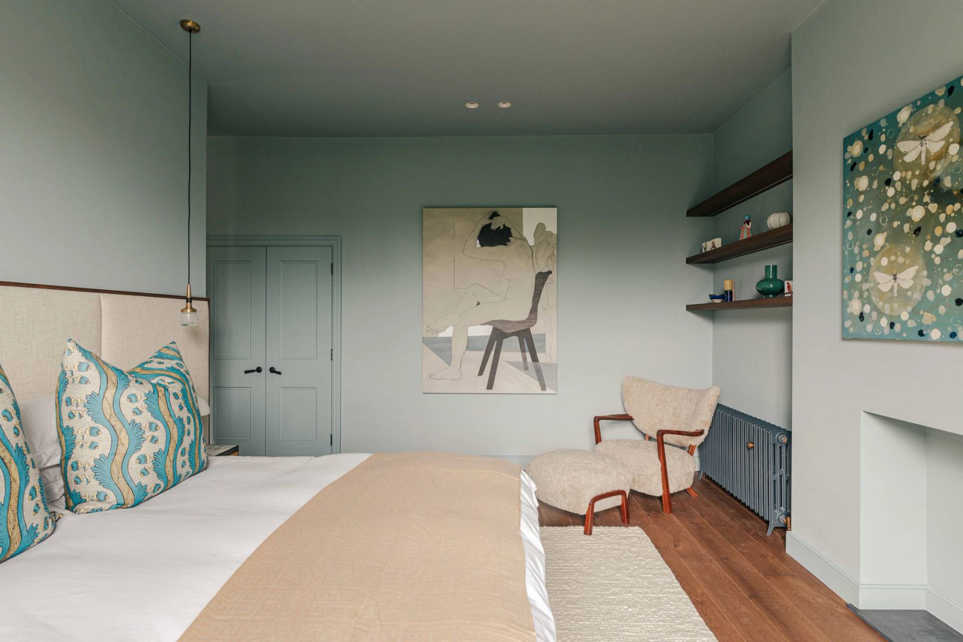 Spacious master bedroom with blue walls, plush beige carpet, and neutral armchair, Love Locations SW13.
