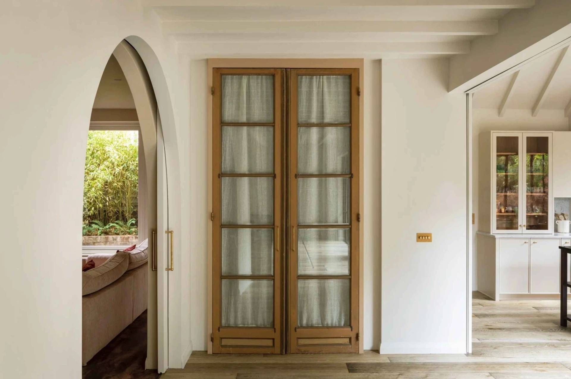 Elegant French glazed double doors set in soft plaster walls inside a character location home in Fortis Green, Highgate, N6, Love Locations.