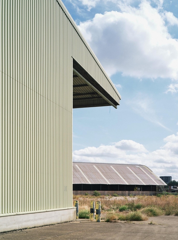 Architectural exterior crop of a modern commercial warehouse canopy kit, providing an industrial backdrop for brand campaigns via Love Locations.
