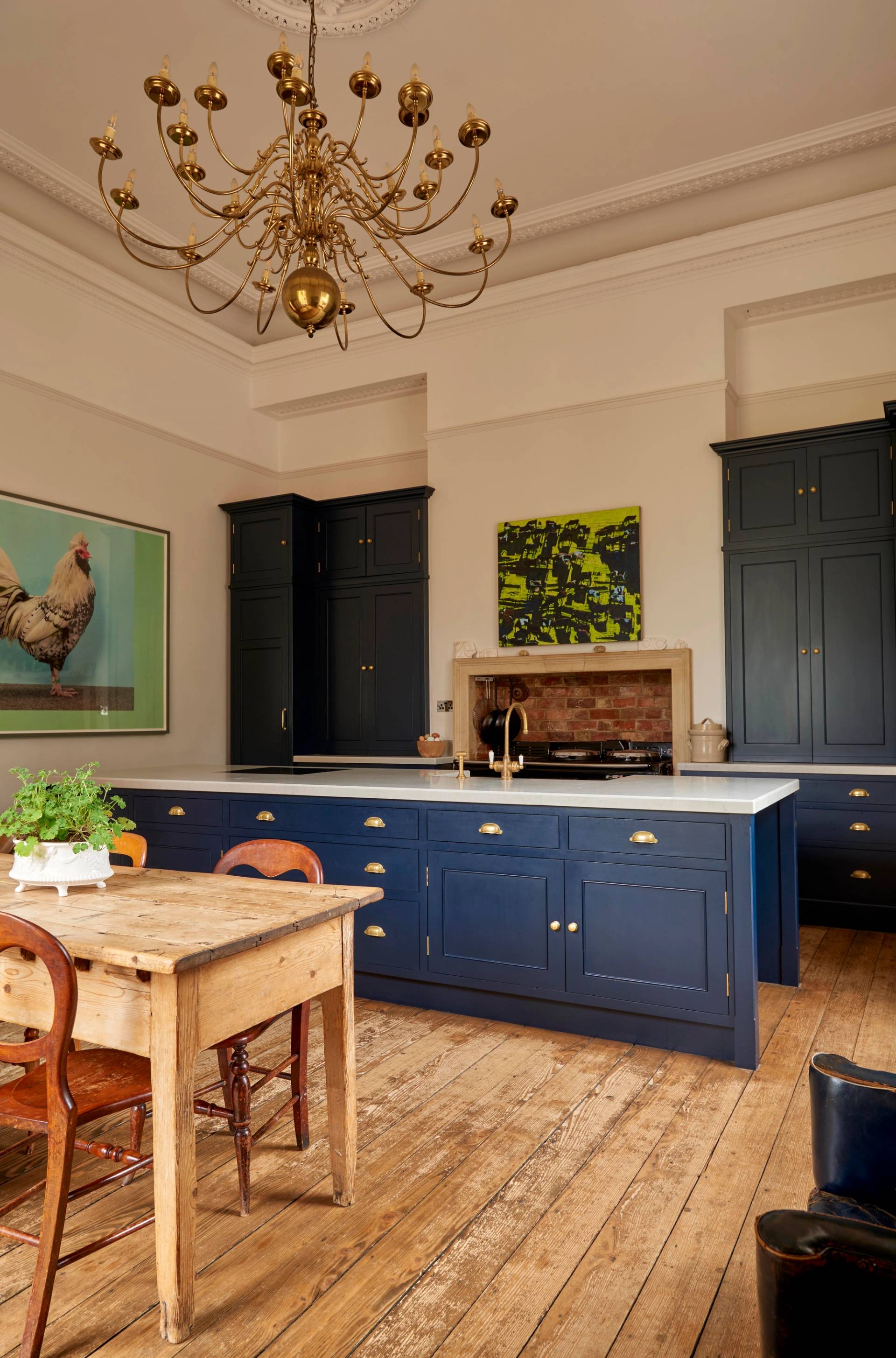 Wide view of a Victorian kitchen showcasing navy island cabinets, a wooden prep table, and high ceilings, ideal for food editorial filming, Love Locations LE7.
