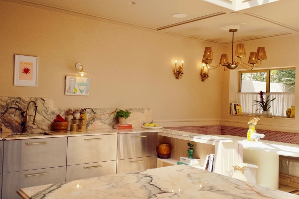 Contemporary kitchen island counter with marble surfaces and warm cream walls, perfect for interior design lookbooks and lifestyle brand advertising, Love Locations TW7.