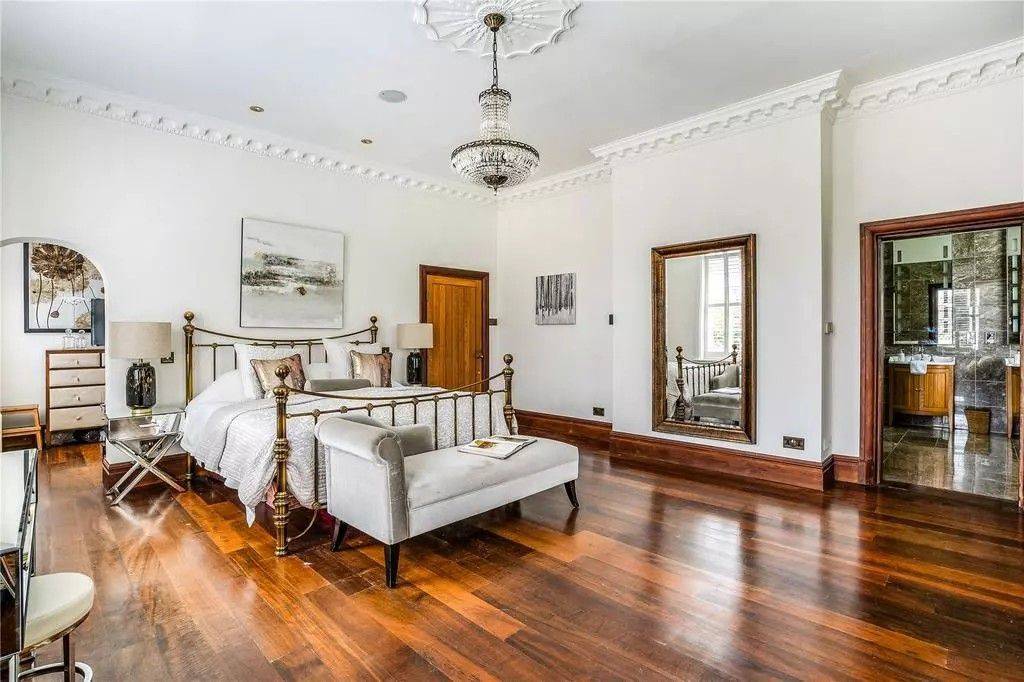Sprawling period bedroom photo location showcasing a mahogany four-poster bed, high decorative ceilings, and rich timber floors via Love Locations.