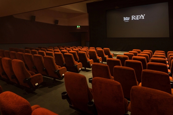 Angled view from the upper auditorium seating looking across the cinema rows toward the screen at The Ritzy Screen 2 shoot location in Brixton SW2 via Love Locations.