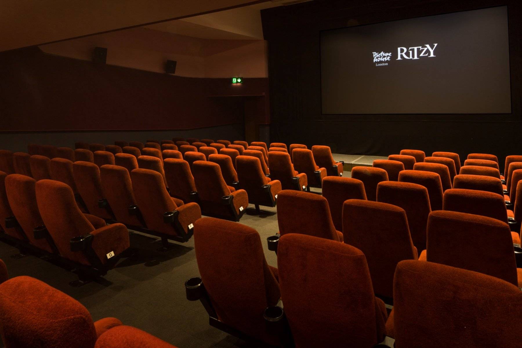 Angled view from the upper auditorium seating looking across the cinema rows toward the screen at The Ritzy Screen 2 shoot location in Brixton SW2 via Love Locations.
