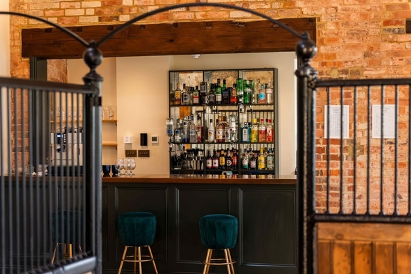 Sophisticated country house cocktail bar set inside a converted rustic barn for private events, curated by Love Locations.