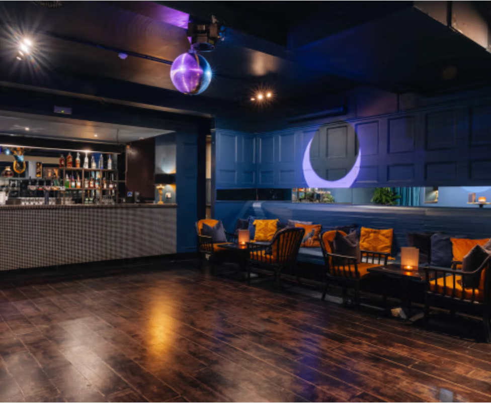 Stylish bar and lounge with dance floor, cosy seating and disco ball, perfect for Christmas parties and festive celebrations.