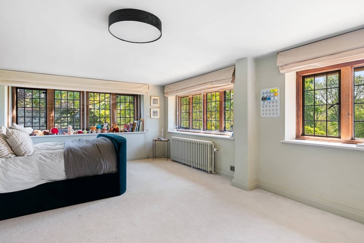 Bright bedroom with grey panelled accent walls, twin windows, and soft neutral decor, Love Locations RH13.