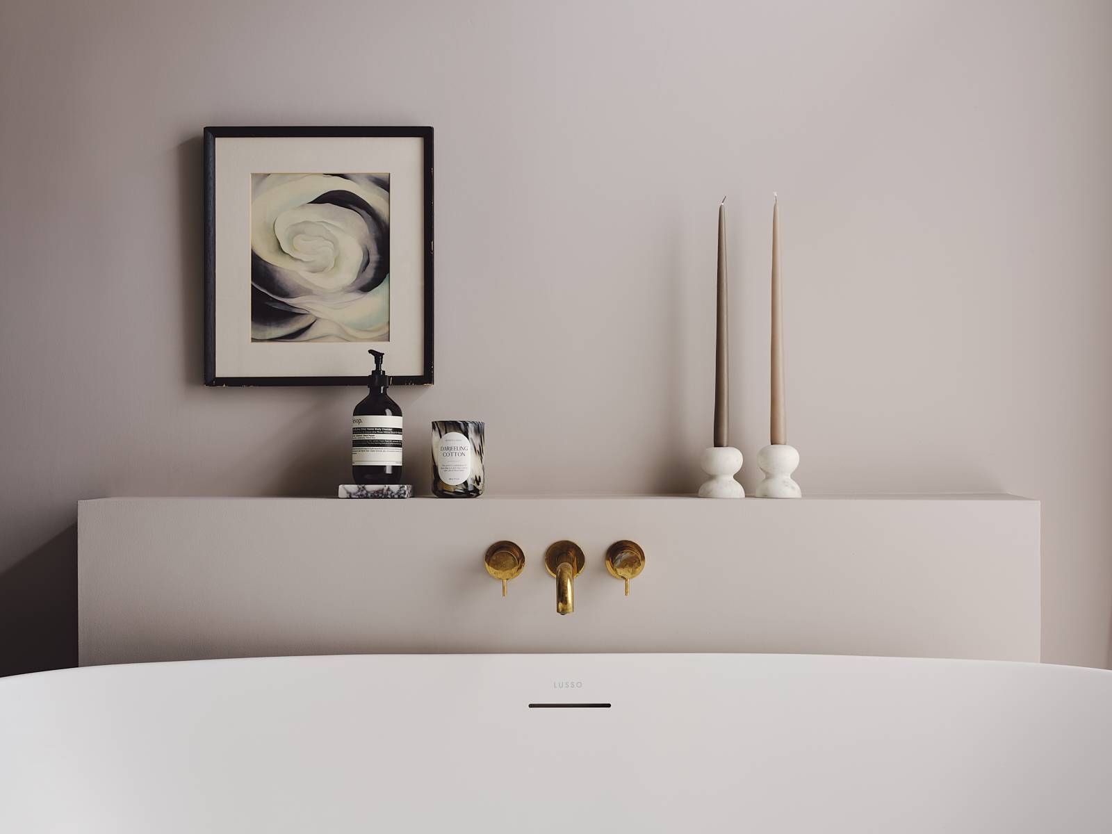 Freestanding bath setup with brass wall-mounted taps set against smooth plaster pink walls, Love Locations CR0.