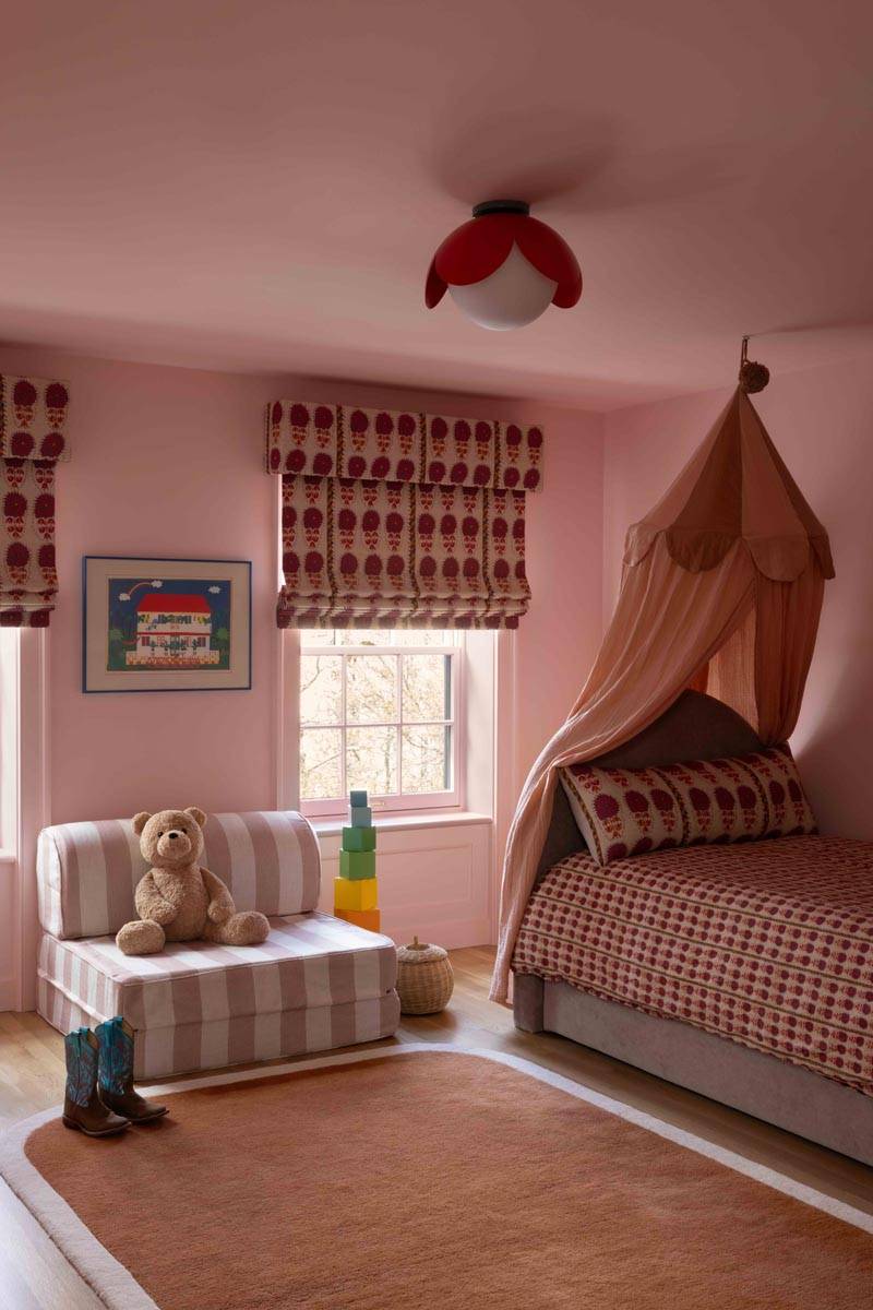 Charming pink nursery or child's bedroom film location in Boerum Hill Brooklyn NY 11217 via Love Locations, featuring a canopy daybed, pink striped wallpaper, and soft lighting.