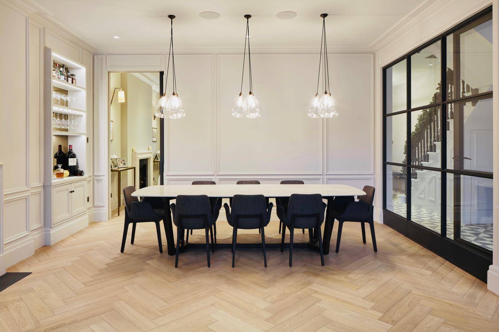 Bright open dining room featuring a white oval table, dark chairs, and panelled walls, Love Locations TW11.
