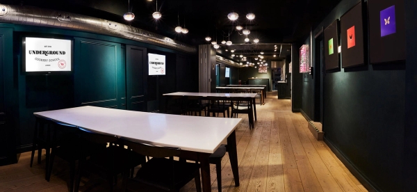 Moody, atmospheric private dining space with warm pendant lighting and wood flooring for corporate hospitality, Love Locations.