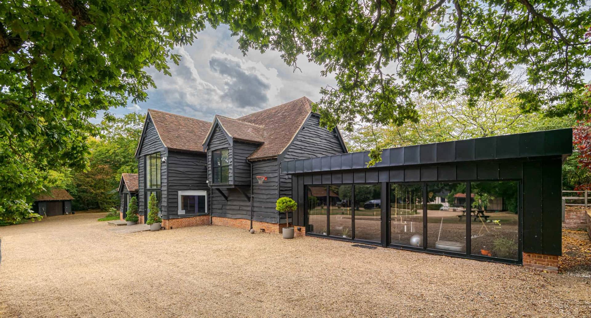 Rear view of barn-style house with gardens in Essex, Love Locations