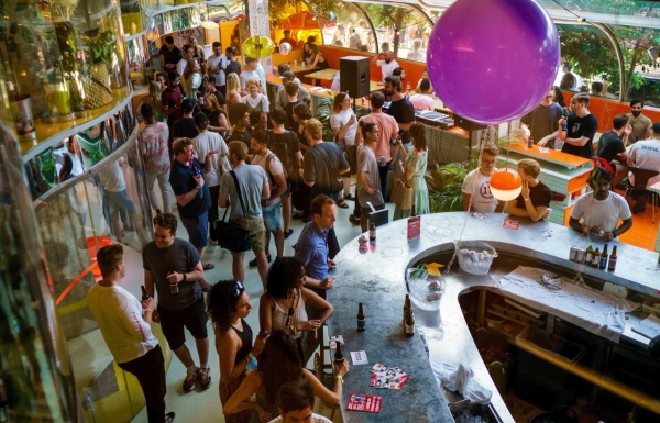 Stylish glass-covered café terrace with orange seating and city views in Whitechapel London E1 – love locations