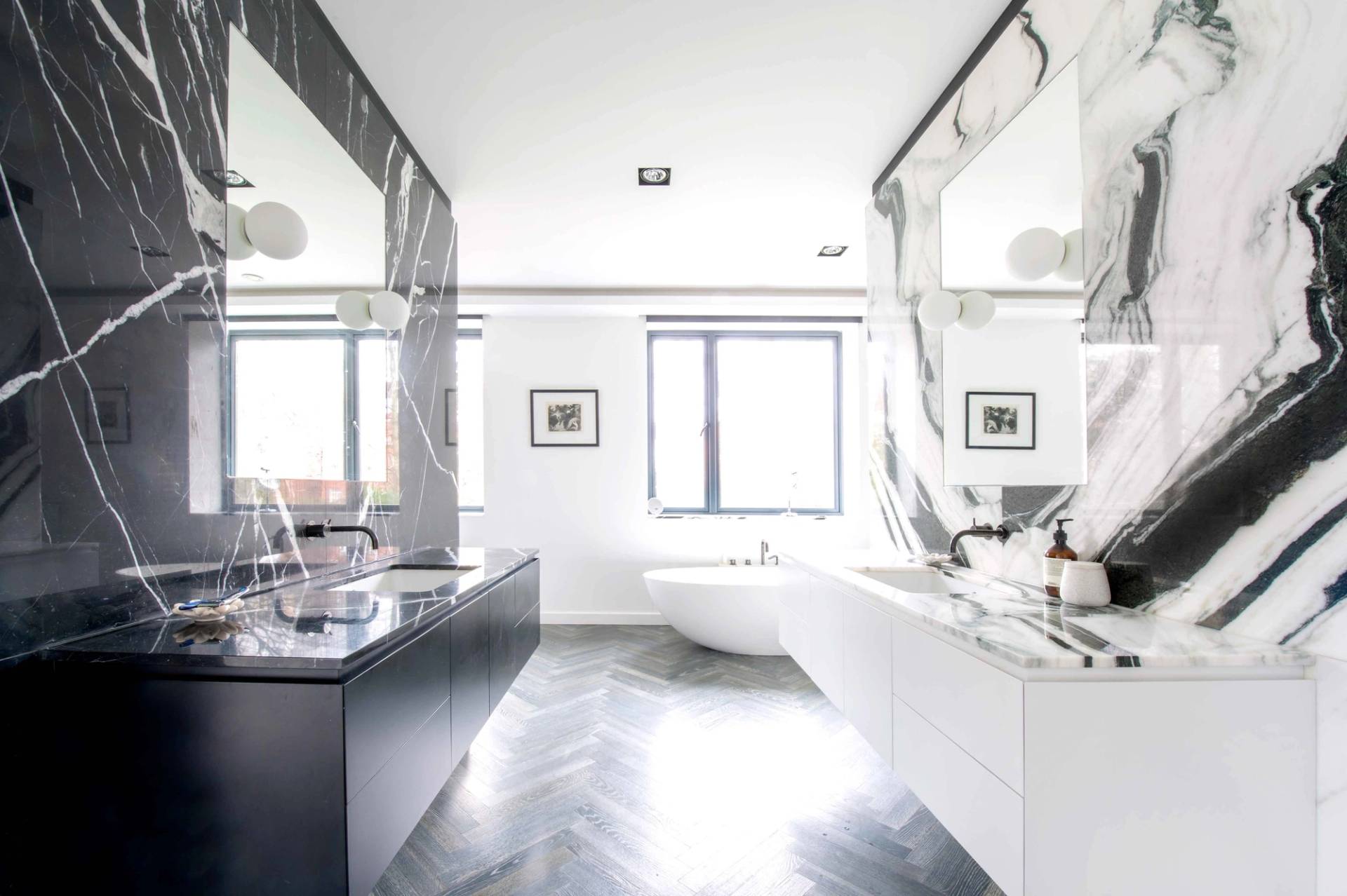 Bright and airy luxury bathroom layout featuring dual marble vanities, a deep soaking tub, and crisp modern architecture, Love Locations.