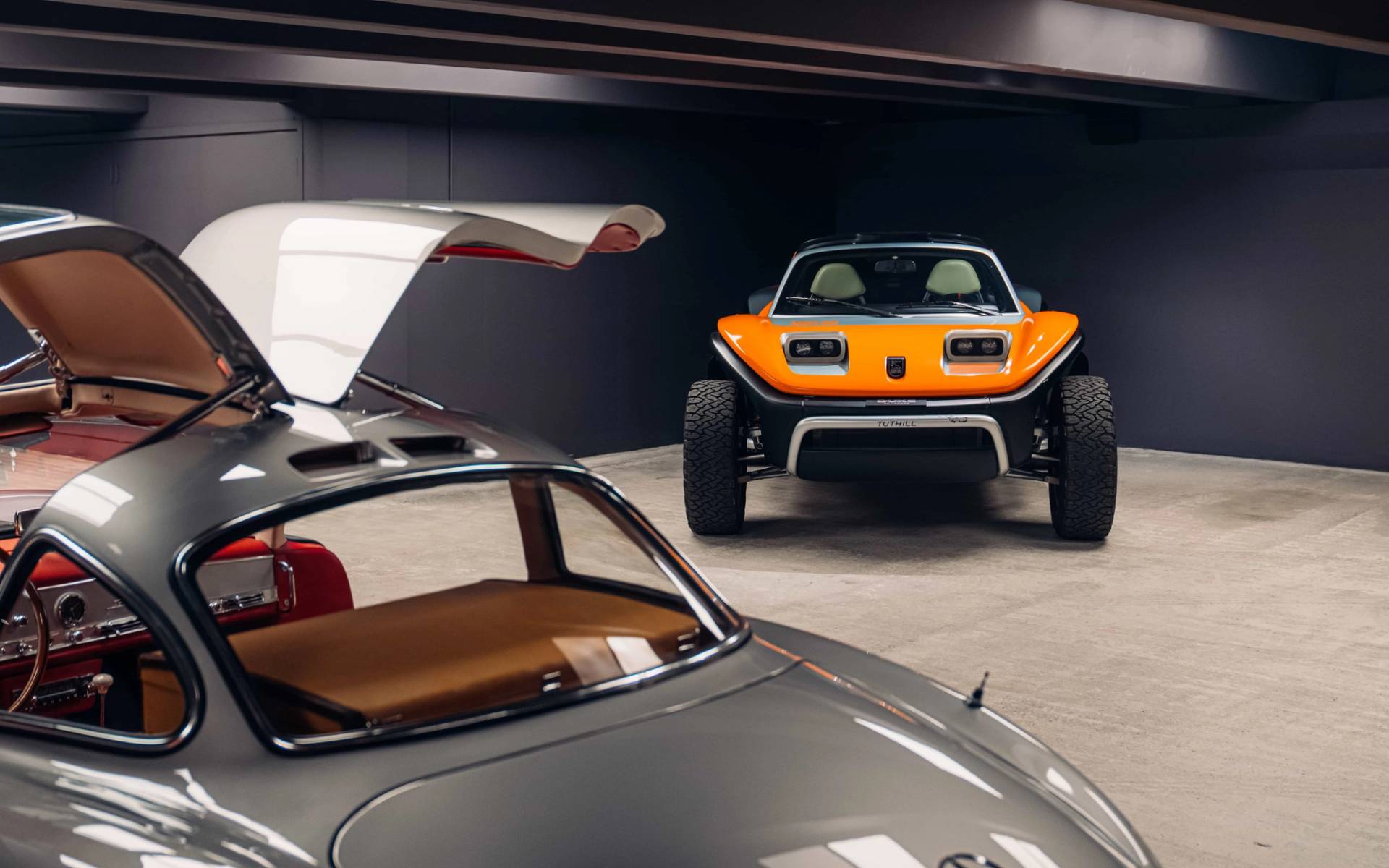 High-end automotive shoot venue in Brentford TW8 from Love Locations, featuring a classic silver sports car and orange buggy beneath recessed ceiling lights.