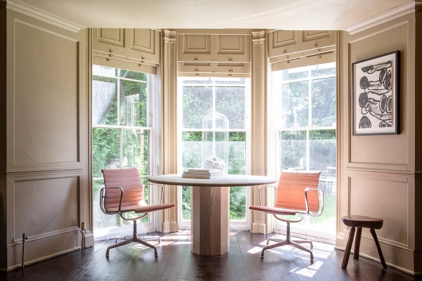 Sash bay window alcove with a round wooden table, orange desk chairs, and green carpet flooring, Love Locations ME13.