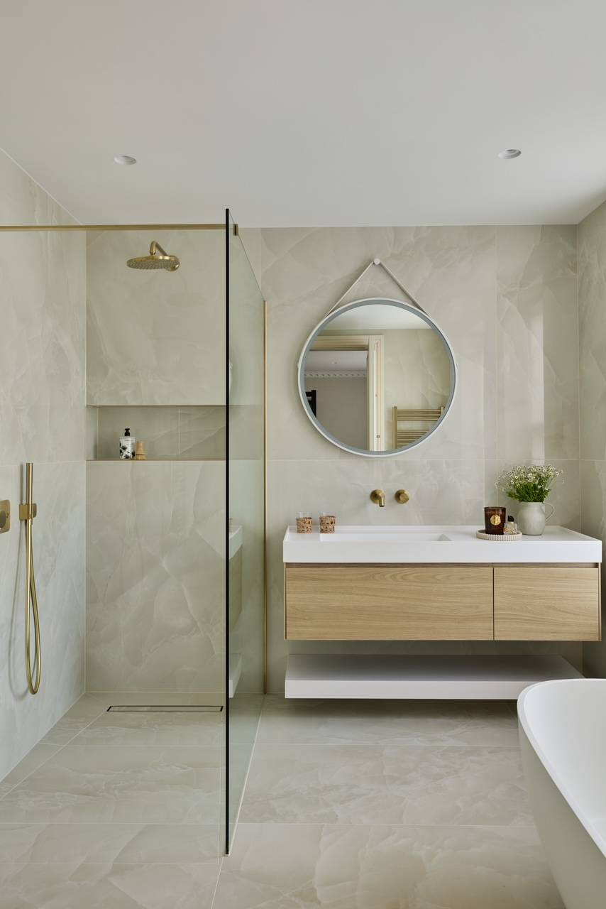 Contemporary walk-in marble shower room with a floating timber vanity and a large circular mirror, suitable for modern architecture lookbooks, Love Locations WD23.