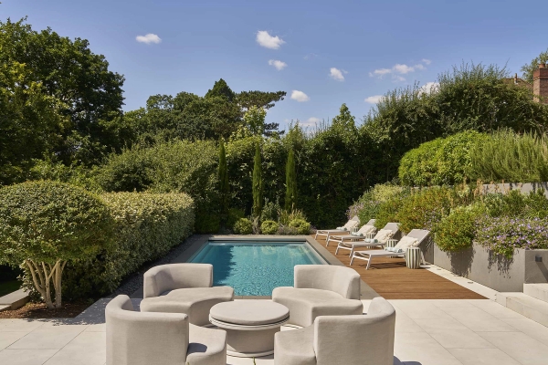 Designer outdoor swimming pool with stone paving and architectural plant borders, perfect for summer shoots, Love Locations.