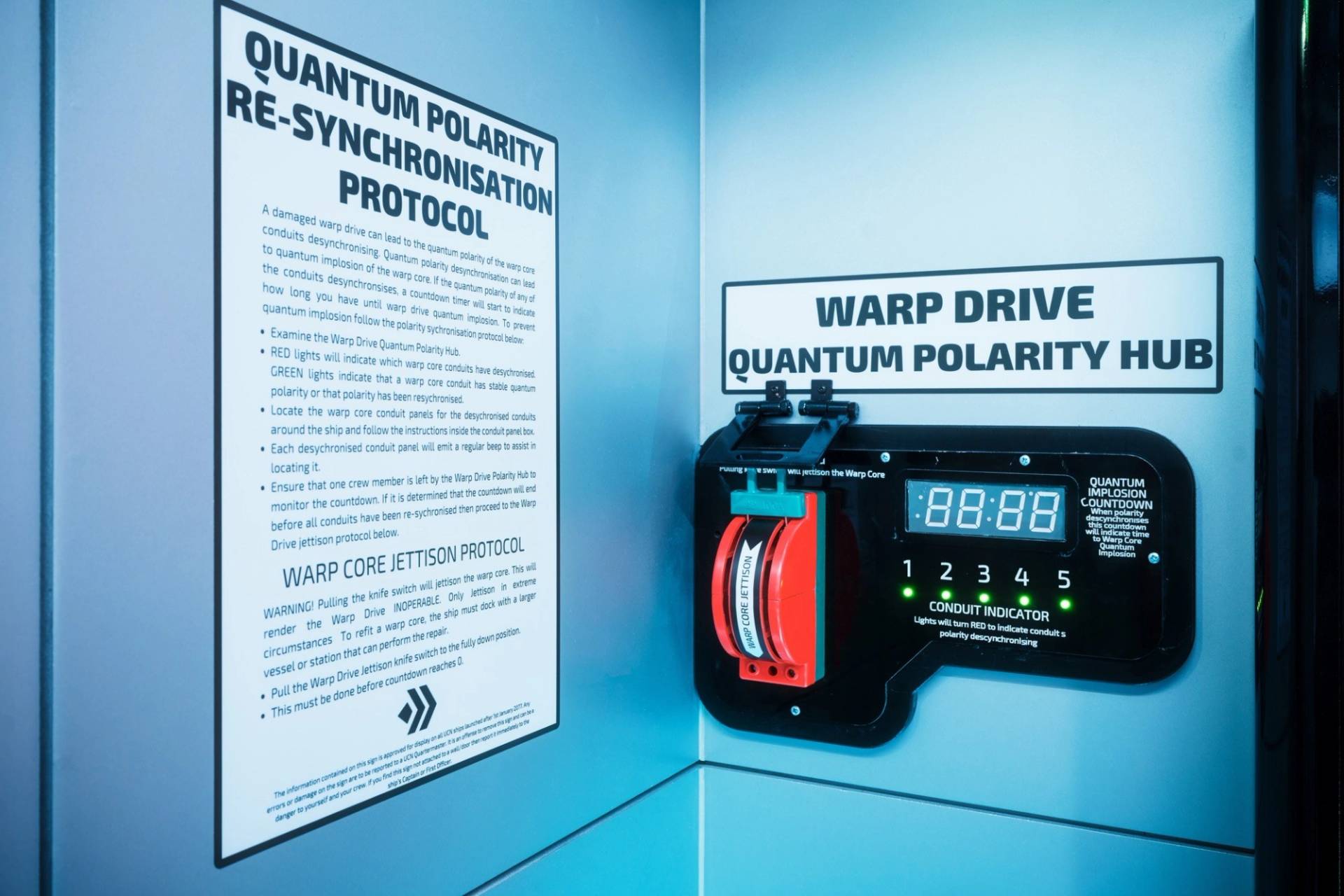 Sci-fi text wall prop outlining a 'Quantum Polarity Re-synchronisation Protocol' next to a warp drive lever, Love Locations.