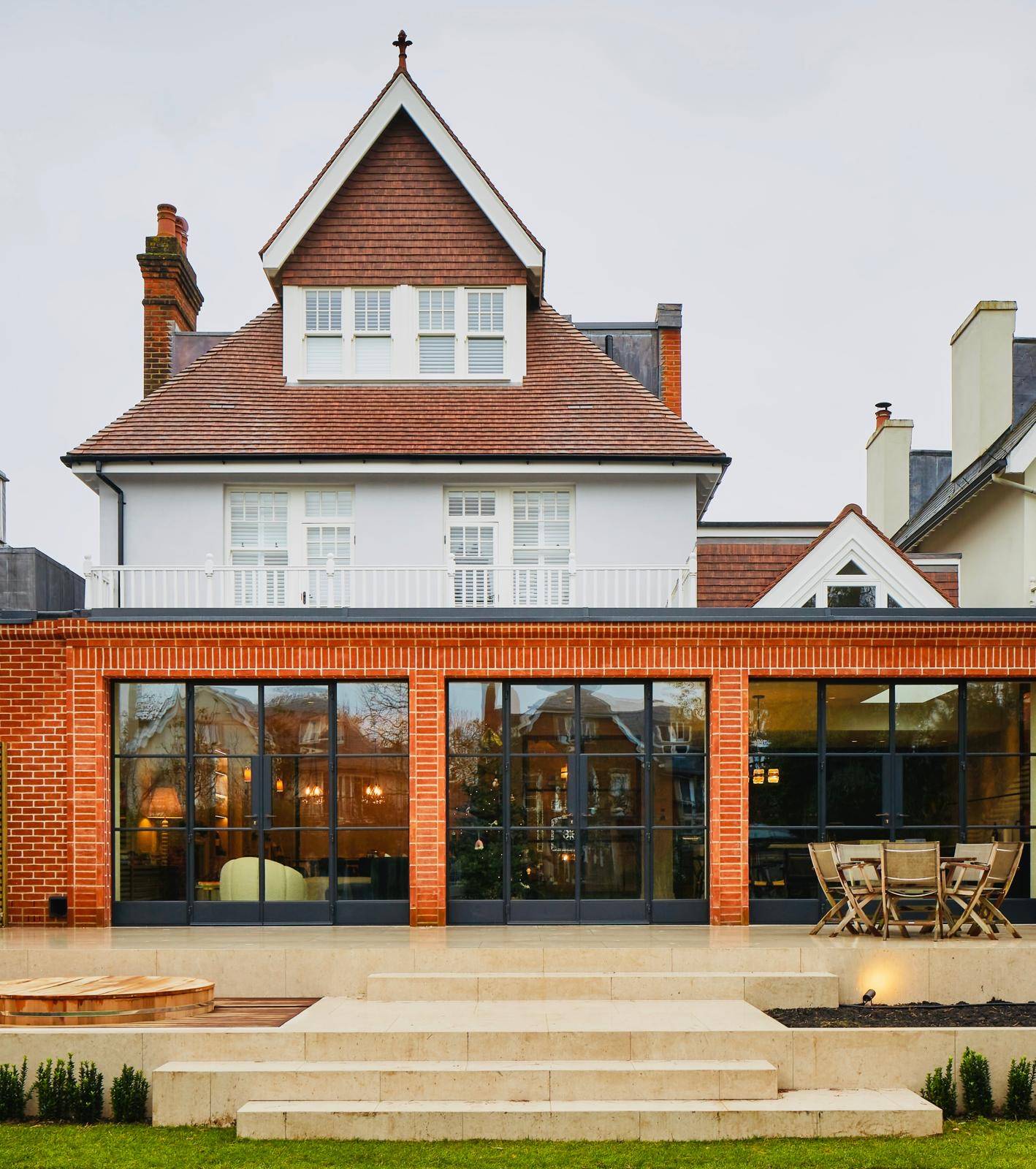 Rear elevation view of a modern red-brick Victorian home extension with Crittall glass doors, Love Locations TW11.