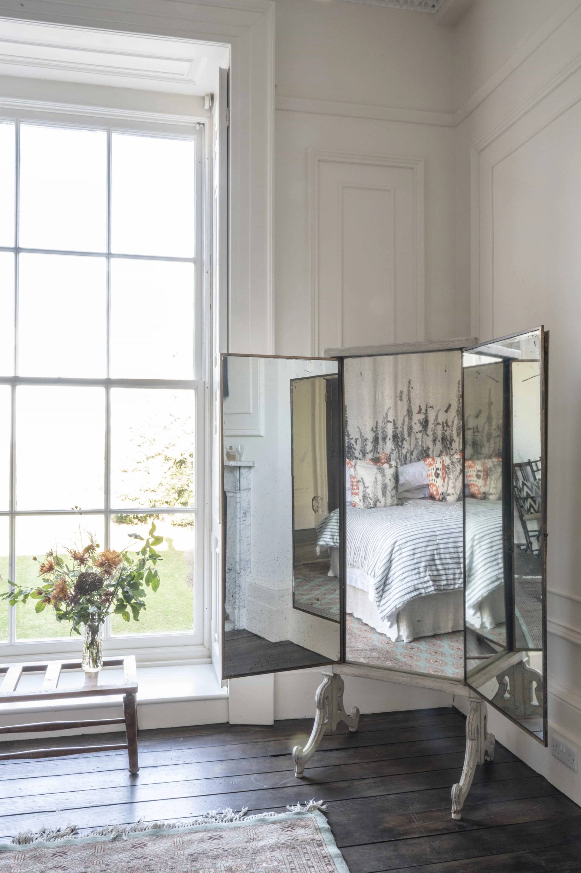 Tri-fold vanity dressing mirror set against a sash window in a light-filled bedroom suite, perfect for beauty product campaigns, Love Locations LE7.