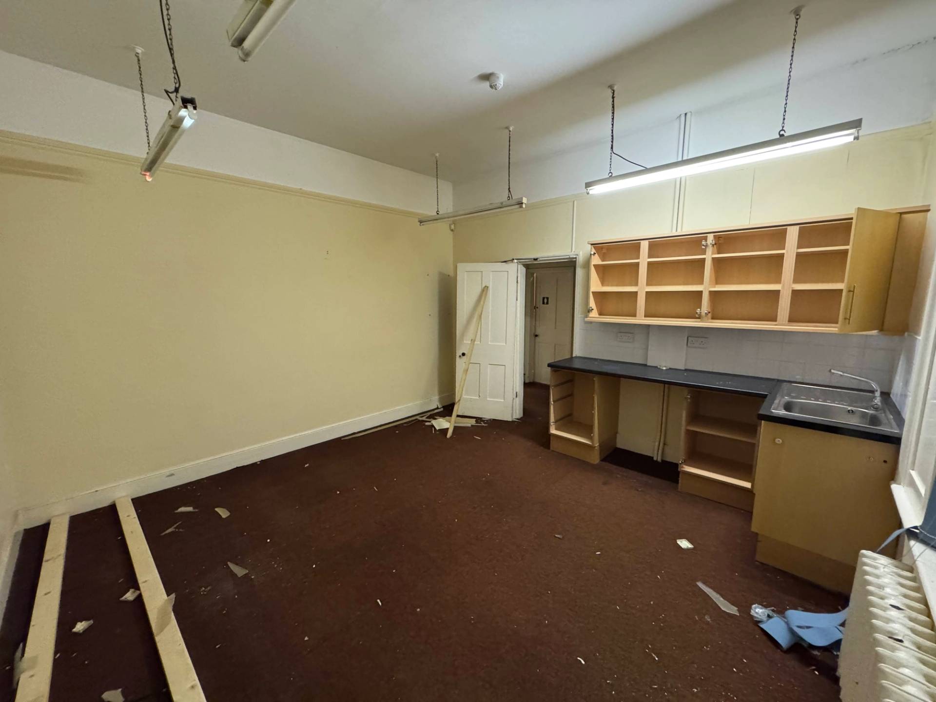 High-angle wide perspective of an abandoned science lab or vintage home economics kitchen space for media hire, Love Locations.