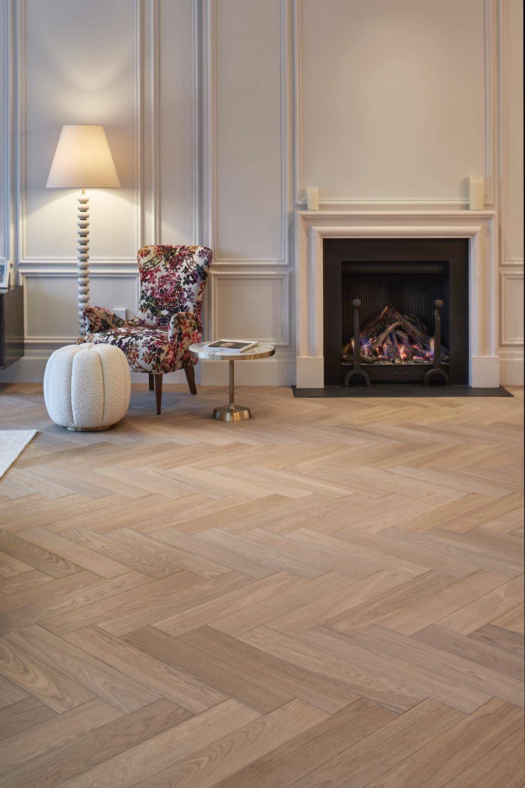 Formal reception room with grey wall panelling, open fireplace, and herringbone floorboards, Love Locations TW11.