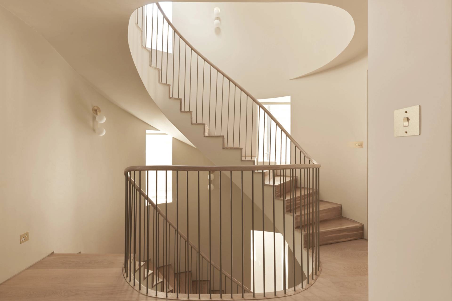 Overhead view of a sweeping spiral staircase design in a contemporary South West London shoot home by Love Locations.