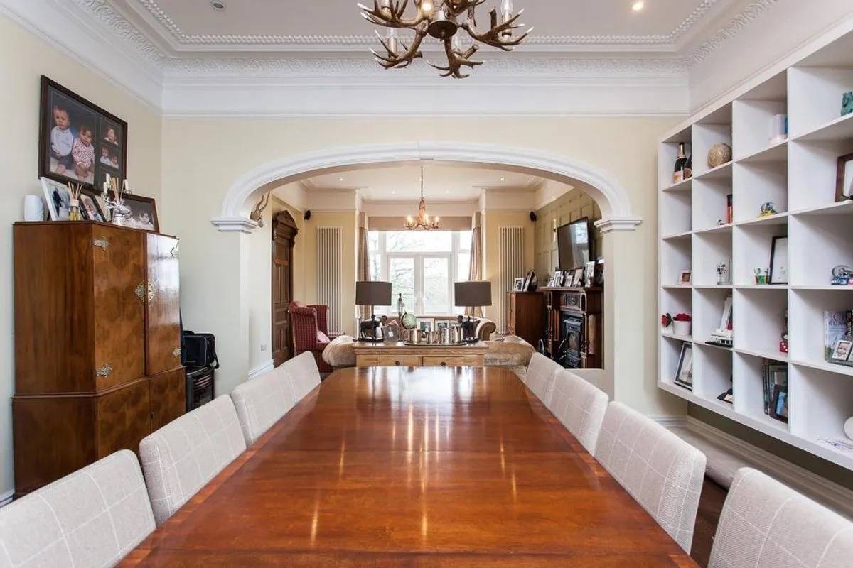 Elegant formal dining room film location in Stockport SK6 through Love Locations, with polished wooden floors, chandelier lighting, and a long dining table.
