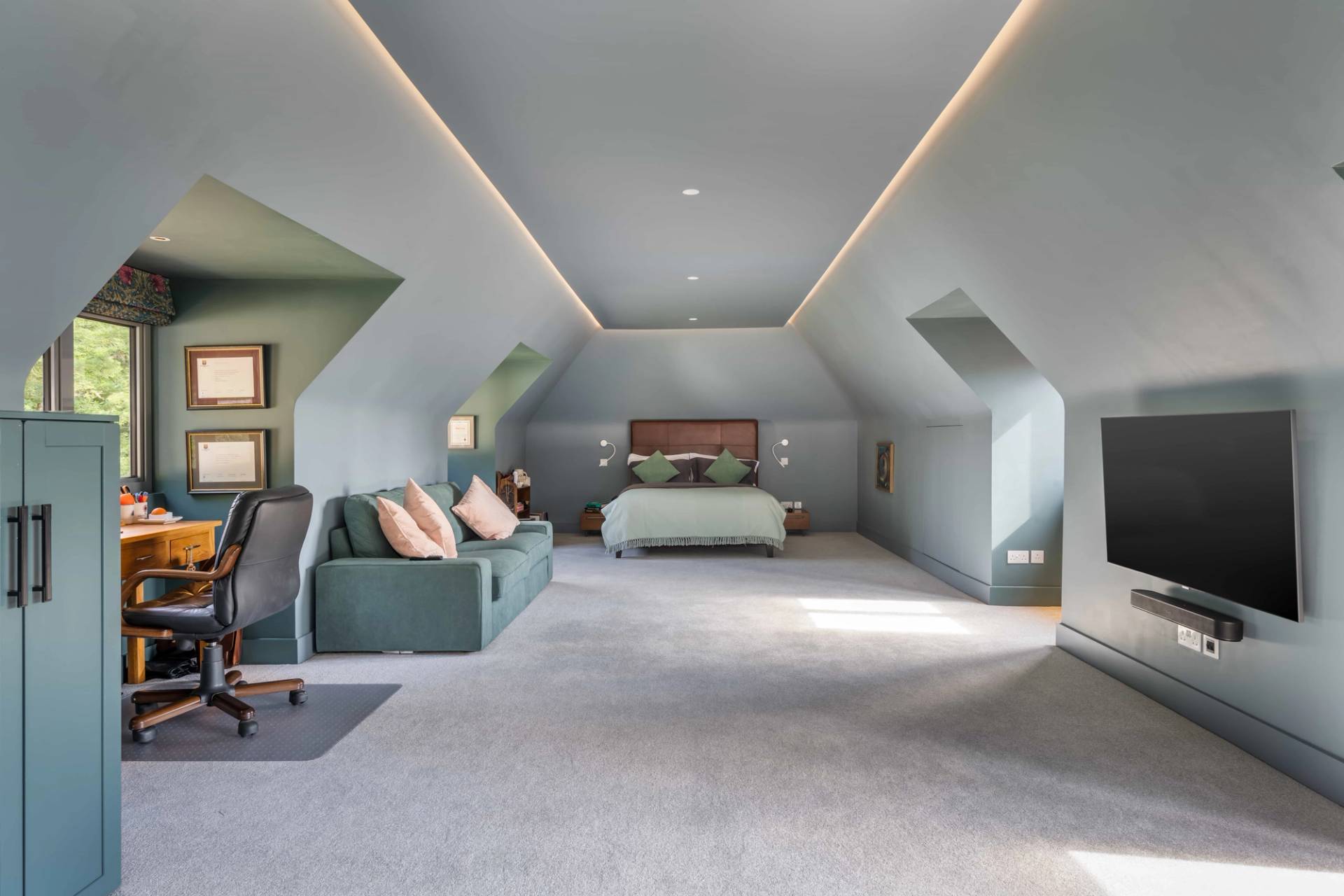 Expansive attic master suite with sloped ceilings, integrated lounge area, and ambient LED lighting, perfect for luxury lifestyle features, Love Locations GU27.