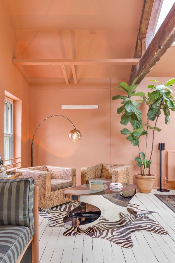 Stylish retro lounge seating area with mid-century modern armchairs and a statement arch lamp, Love Locations studio.