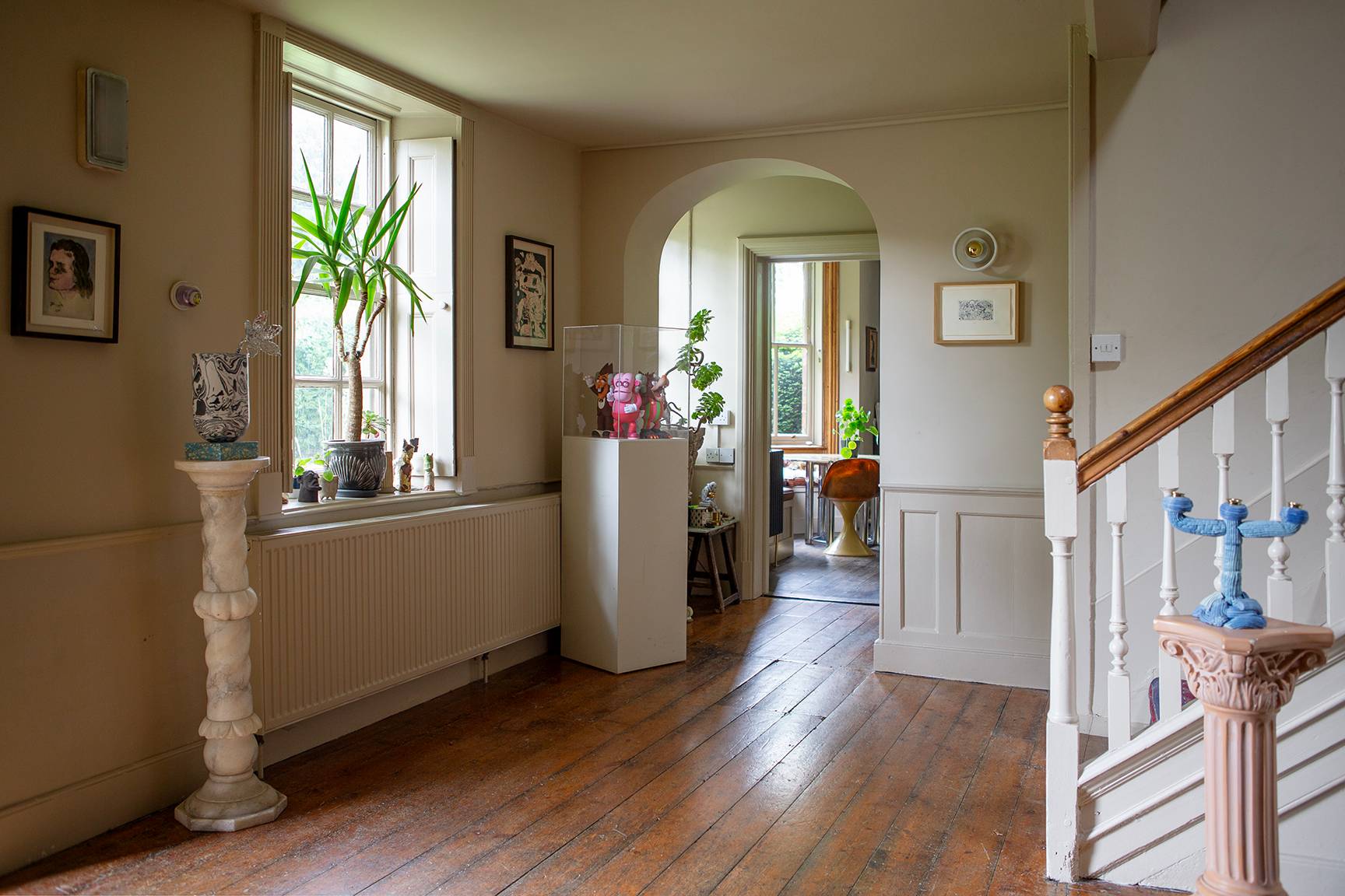 Grand entrance hall with dark wood flooring, white staircase, and open doorway transitions, Love Locations ME13.
