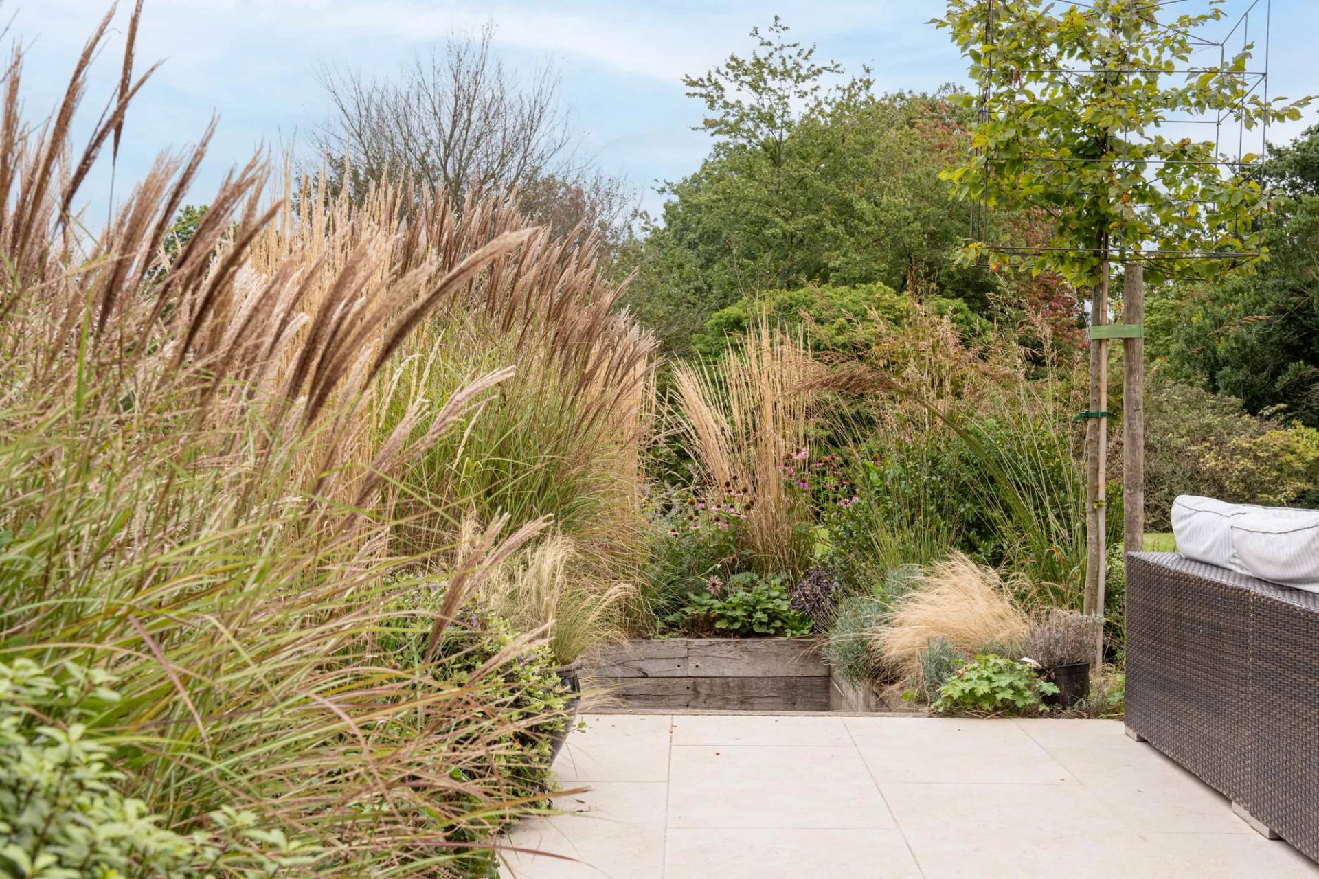 Stone garden steps leading up through ornamental grass flower beds, Love Locations GU28.