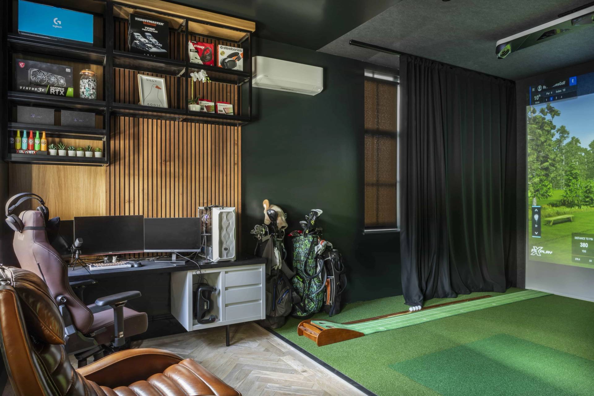 Golf simulator studio featuring slatted wood wall panelling, dark drapes, and green putting turf, Love Locations HP18.
