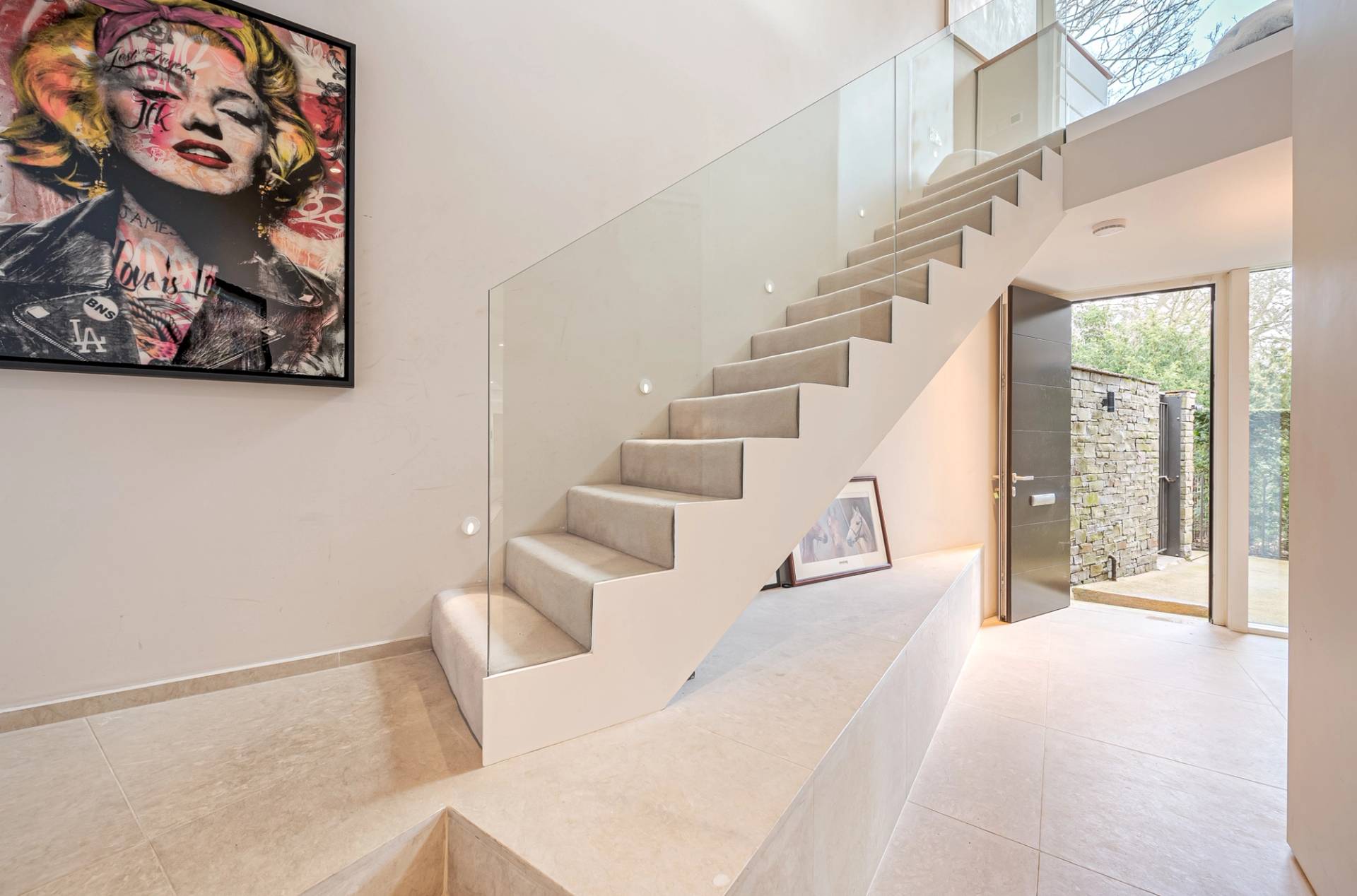Architectural stone staircase with frameless glass balustrades and polished concrete steps, Love Locations KT2.