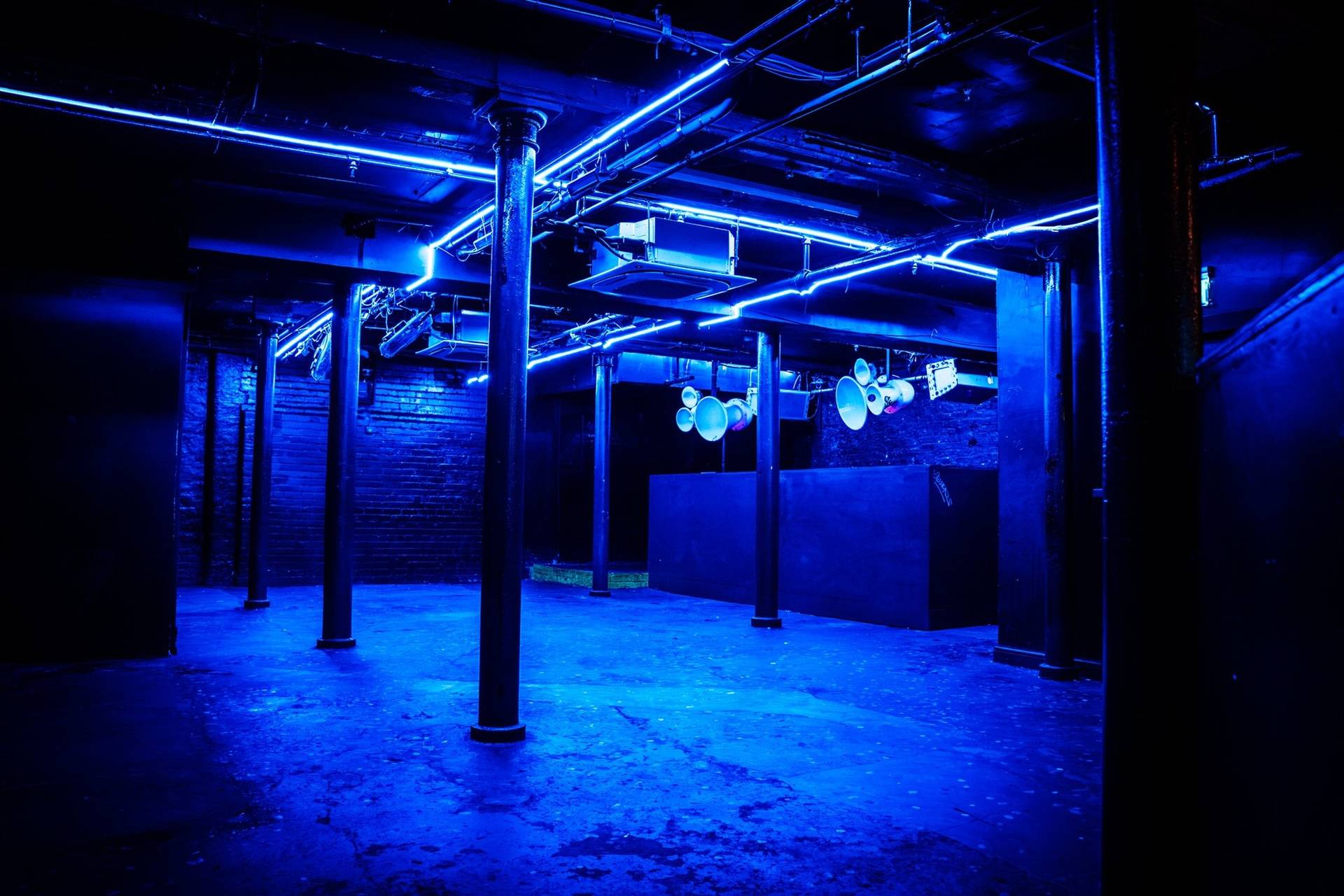 Deep blue neon illuminated underground club space for film and TV hire in Cheetham Hill Manchester M3 from Love Locations.
