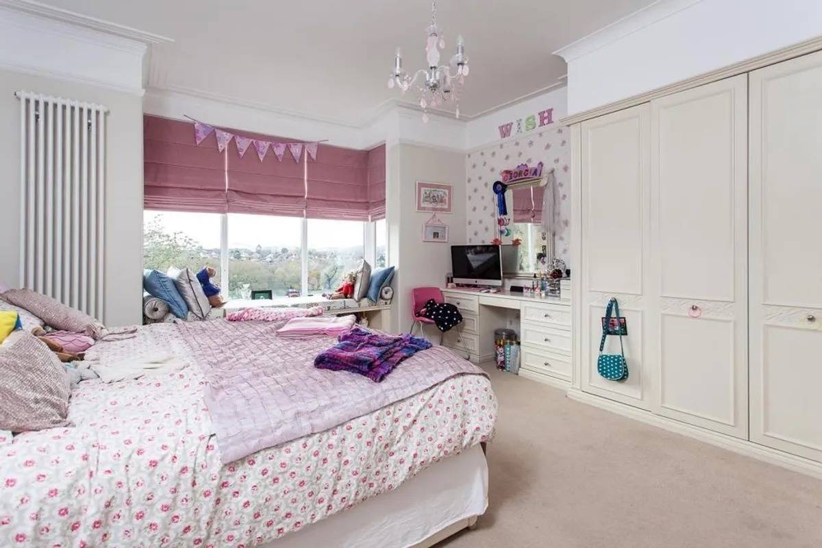 Pink children’s bedroom photoshoot location in Stockport SK6 by Love Locations, featuring bay windows, built-in wardrobes, and study desk.