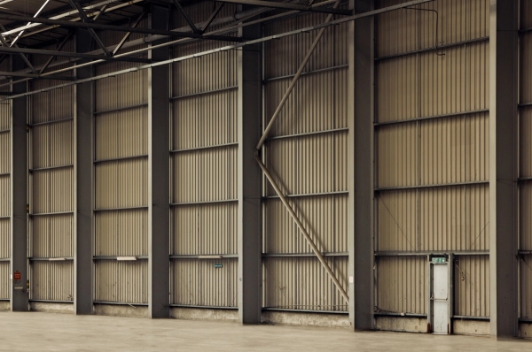 Industrial corrugated metal wall backdrop inside a blank canvas warehouse location house for fashion lookbooks and gritty media production, Love Locations.