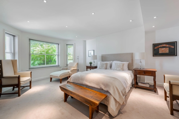 Sunlit master bedroom showcase with a wooden bench at the foot of the bed and large bay windows, ideal for lifestyle digital content creation, Love Locations W4.
