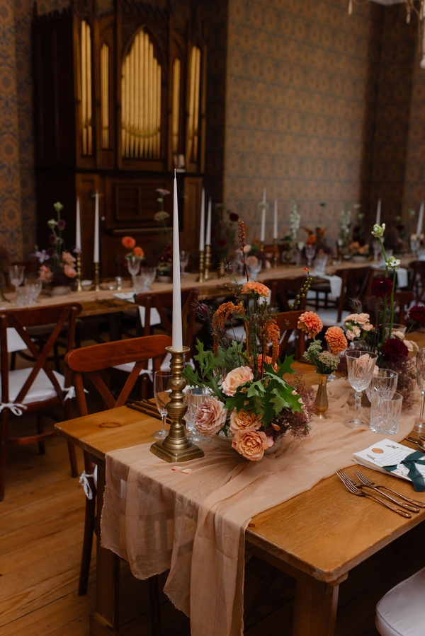 Candlelit rustic dining table layout with brass candlesticks and floral arrangements, Love Locations KY15.
