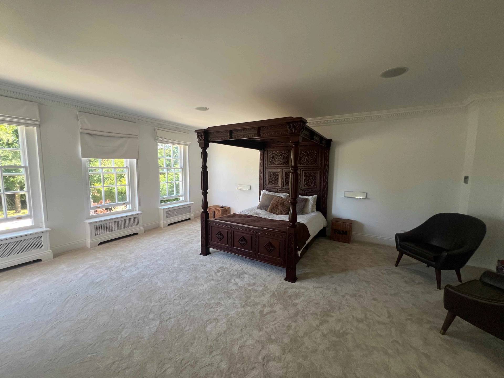 Master bedroom suite featuring a carved dark mahogany four-poster bed and neutral carpets in BR7, Love Locations.