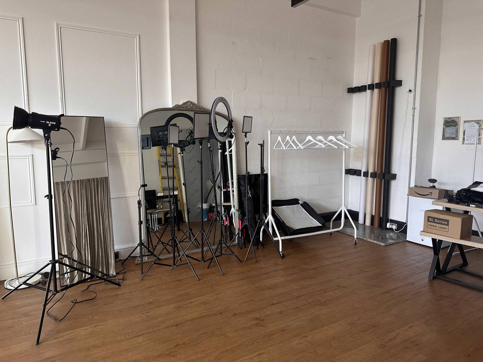 Creative studio equipment setup area featuring clothes rails, ring lights, backdrop paper rolls, and full-length mirrors hero cover image in Battersea, SW8, the ultimate high-visibility backdrop for commercial video shoots, fashion lookbooks, and brand campaigns via Love Locations.
