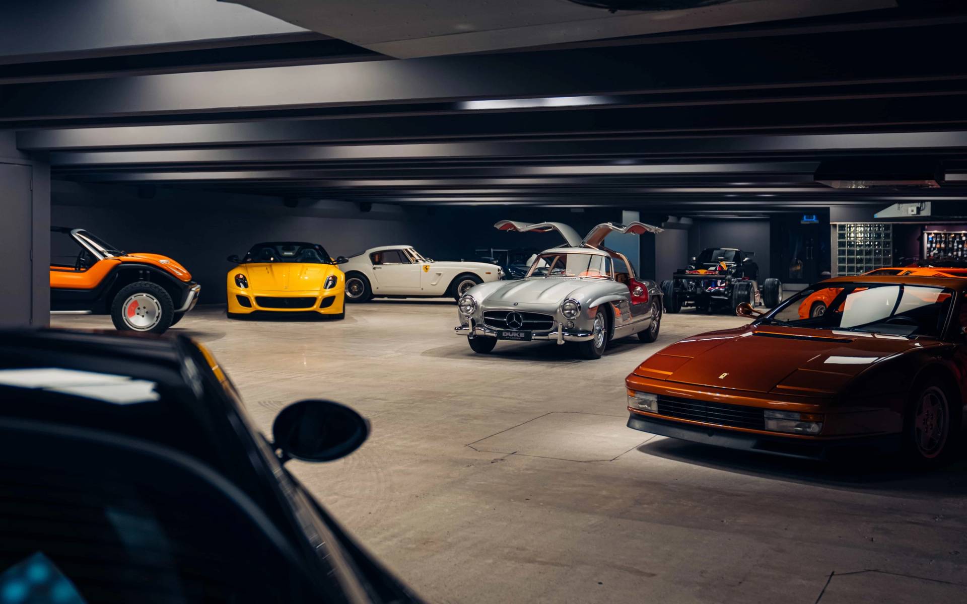 Broad view across a subterranean bunker location house housing classic and modern supercars in Brentford TW8 from Love Locations.