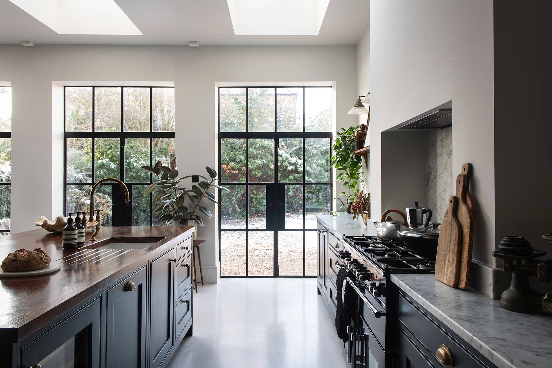 Full-height black metal Crittall glass patio doors opening into a green garden in Streatham, perfect for lifestyle campaigns, Love Locations SW16.