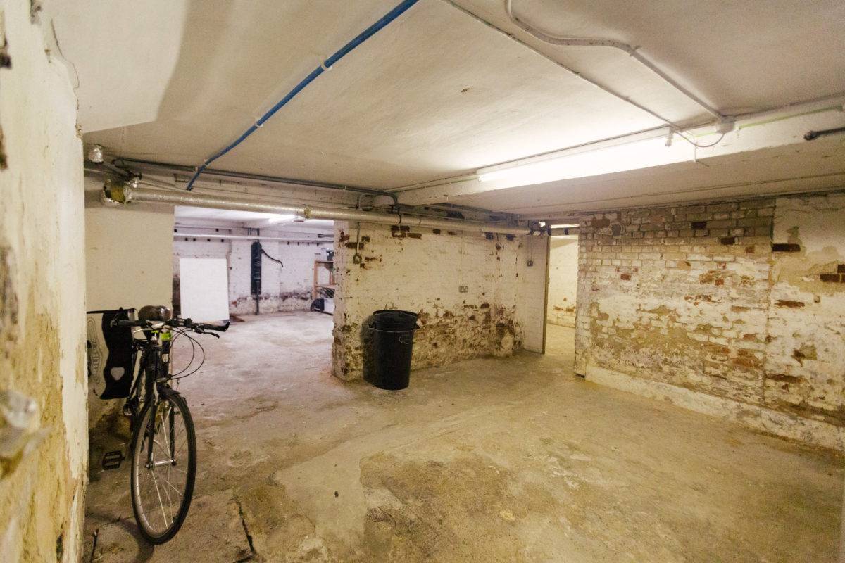 Unfinished brick basement vault with exposed pipework and concrete floors, ideal for gritty music video shoots, Love Locations.