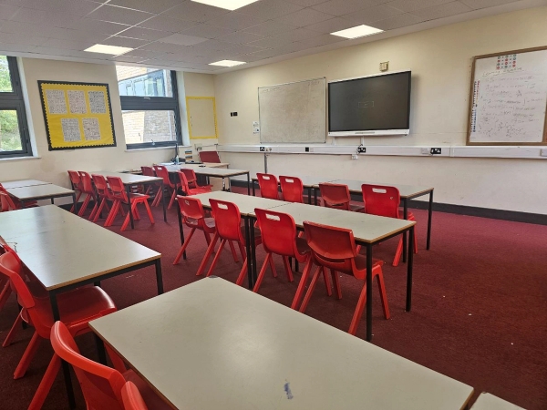 Contemporary secondary school classroom set with interactive whiteboard and teacher desk for corporate or film use, Love Locations.
