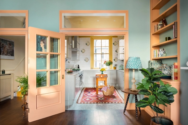 Bright, open-plan kitchen and hallway shoot location in Westminster London SW1V available from Love Locations, featuring pastel tones and glass-panelled doors.