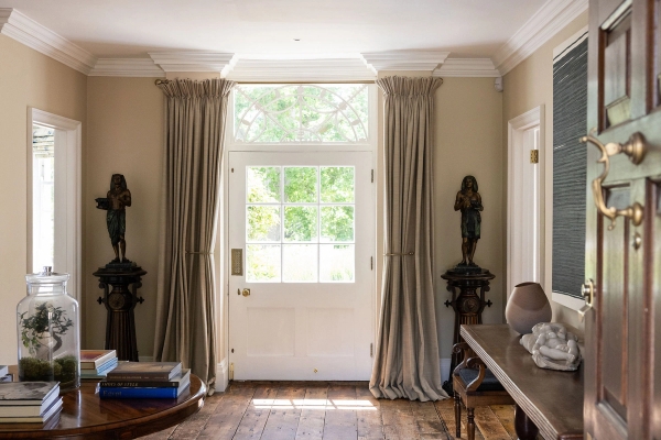 Love Locations grand country house hallway BN44: Stately entrance vestibule door framed by sweeping floor-length drapes and classic columns, an elegant setting for arrival or departure film scenes.